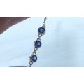 A PETITE YET ELEGANT SOLID STERLING SILVER BRACELET SET WITH 3 FACETED BLUE STONES !! BRAND NEW !!