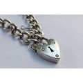 A VINTAGE SOLID STERLING SILVER STARTER CHARM BRACELET WITH HEART CLASP - STAMPED AND TESTED