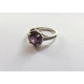 A CLASSY SOLID STERLING SILVER RING SET WITH A FACETED PURPLE STONE AND SMALL CLEAR STONES !! TESTED