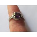 A CLASSY SOLID STERLING SILVER RING SET WITH A FACETED PURPLE STONE AND SMALL CLEAR STONES !! TESTED