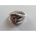 A STYLISH SOLID STERLING SILVER RING SET WITH A FACETED RED STONE !! STAMPED AND TESTED !!