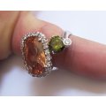 AN EXQUISITE STERLING SILVER RING SET WITH CITRINE COLORED , GREEN AND AND A CLEAR FACETED STONE !!