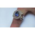 A GORGEOUS SOLID STERLING SILVER RING SET WITH A FACETED BLUE STONE AND CLEAR STONES !! MUST SEE !!