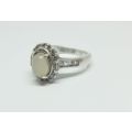 R1 START !! A solid Sterling Silver ring set with a white cabochon stone and faceted stones !! LOOK