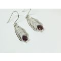 AN ELEGANT PAIR OF SOLID STERLING SILVER EARRINGS SET WITH FACETED RED STONES !! NEVER WORN !!
