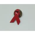 A vintage red ribbon lapel pin ( fight against Aids )