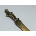 An antique solid brass boy from Bruxelles theme letter opener