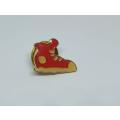 A vintage ankle boot badge / lapel pin