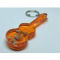 A VINTAGE GUITAR SHAPED KEYRING CONTAINING SEA `LIFE ` FROM THE SEYCHELLES