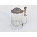 A vintage cut glass tankard with hinged pewter lid