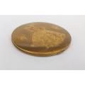 A vintage powder compact with lots of character featuring a stylish young lady