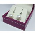 A pair of genuine sterling silver and freshwater pearl earrings - Never worn - With box