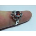 A genuine sterling silver ring with floral design and faceted red inset - Brand new