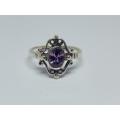 A genuine sterling silver ring with gable design and faceted purple inset - Brand new