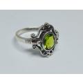 A genuine sterling silver ring with gable design and faceted green inset - Brand new