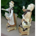 A PAIR OF VICTORIAN BISQUE SPILL VASE FIGURINES, A FARMER ND HIS WIFE.