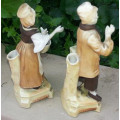 A PAIR OF VICTORIAN BISQUE SPILL VASE FIGURINES, A FARMER ND HIS WIFE.