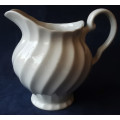 DELICATE LOOKING, WHITE JUG, MADE IN ENGLAND WITH A PRETTY SWIRLING DESIGN,