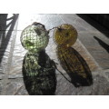 Pair of vintage glass fishing floats with netting