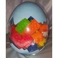 Egg shaped container with building blocks