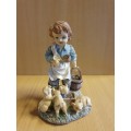 Boy Figurine Feeding Piglets