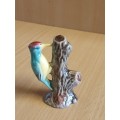 Small Porcelain Woodpecker on a Tree Stump