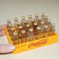 24 Miniature Coca Cola bottles in a plastic crate - Bottle height 65mm - Crate 150mm X 100mm