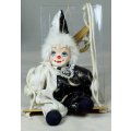 A SMALL CLOWN IN A WIZARD JUMP SUIT ON A SWING - BID NOW!!!