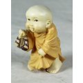 A BABY BUDDHA - CARRYING HIS SHOES WITH HIS TONGUE STICKING OUT - BID NOW!!!!