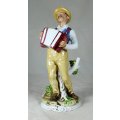 A SPECIAL PORCELAIN OLD MAN PLAYING THE ACCORDIAN - BID NOW!!!!