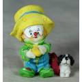 MOLDED CLOWN IN A LARGE YELLOW HAT WITH HIS DOG