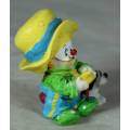 MOLDED CLOWN IN A LARGE YELLOW HAT WITH HIS DOG