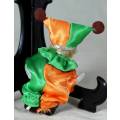 PORCERLAIN AND CLOTH CLOWN IN A GREEN AND ORANGE SUIT