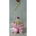 PORCERLAIN AND CLOTH CLOWN DRESSED IN PINK ON A ROPE