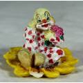 CERAMIC CLOWN SITTING IN A SUNFLOWER HOLDING A BUNCH OF ROSES (LOVELY) -BID NOW !!!