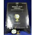 EXQUISITE HACHETTE MINITURE CLOCK WITH BOOKLET-ROTATING GLOBE-BID NOW!