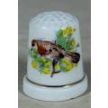 PORCELAIN THIMBLE-WITH A BIRD AND YELLOW FLOWERS(LOVELY)BID NOW!!!!!