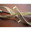 Vintage Art Deco Brooch In Gold Toned Metal In Form Of A Bow Tie With Red Glass Stone