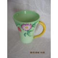 Carlton ware mug in mint green and yellow, embossed with flowers