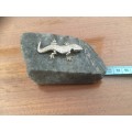 SA mining silver Gecko sitting on rock