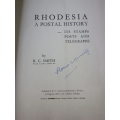 `RHODESIA - A POSTAL HISTORY ` HC + DW BOOK + SOFT COVER BOOKLET -  BOTH SIGNED    (1030)