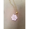 Delicate gold tone fashion necklace with pink enamel flower pendant