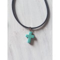 Black rubber cord necklace with imitation turquoise howlite cross pendant The necklace has an extend