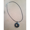 Black waxed cord / faux leather necklace with unusual round pendant The necklace has an extender cha