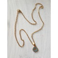Delicate gold tone fashion necklace with cute blue flower pendant