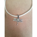 White suede leather cord choker necklace with alloy metal dragonfly pendant The necklace has an exte