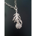 Silver tone fashion necklace with alloy metal feather pendant