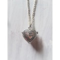 Silver tone fashion necklace with stunning heart locket pendant with rose quartz gemstone inside