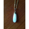 Silver tone fashion necklace with gold tone edge oval shell pendant