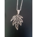 Silver tone fashion necklace with palm leaf pendant